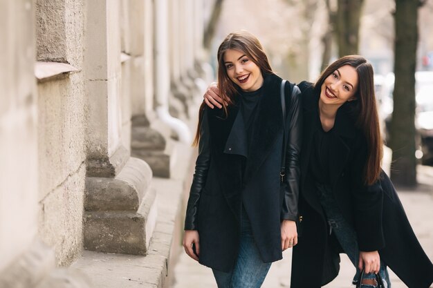 Smiling friends walking down the street