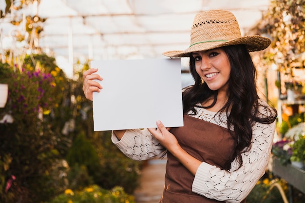 Smiling gardener with paper sheet