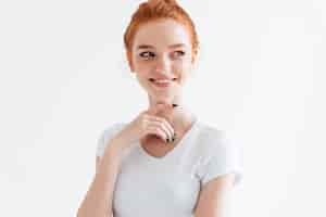 Free photo smiling ginger woman in t-shirt looking away