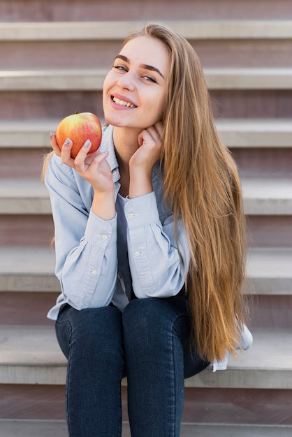 Smiling girl holding a delicious apple