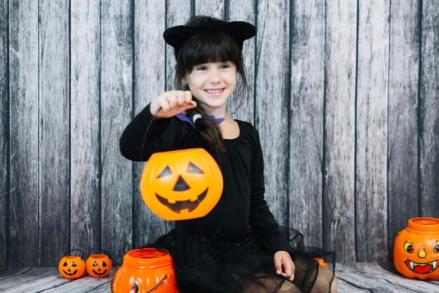 Smiling girl holding trick or treat basket