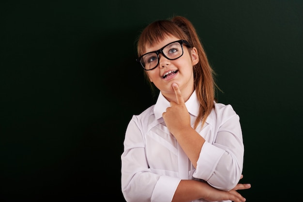 Smiling girl intensively planning something