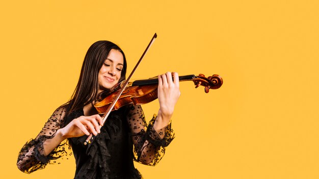 Smiling girl playing the violin