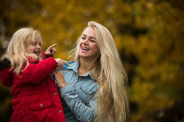 Smiling girl pointing at something to her mother