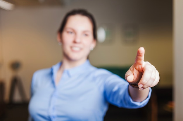 Smiling girl pointing with finger