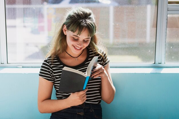 Smiling girl reading in school