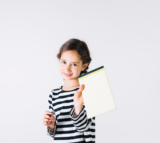 Smiling girl showing notebook