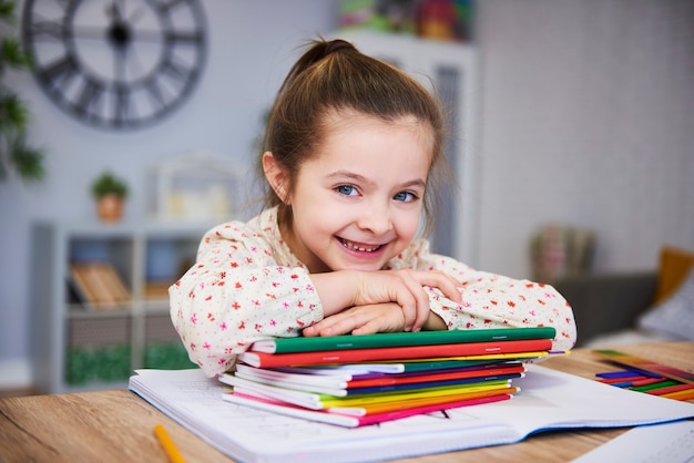 Smiling girl studying at home