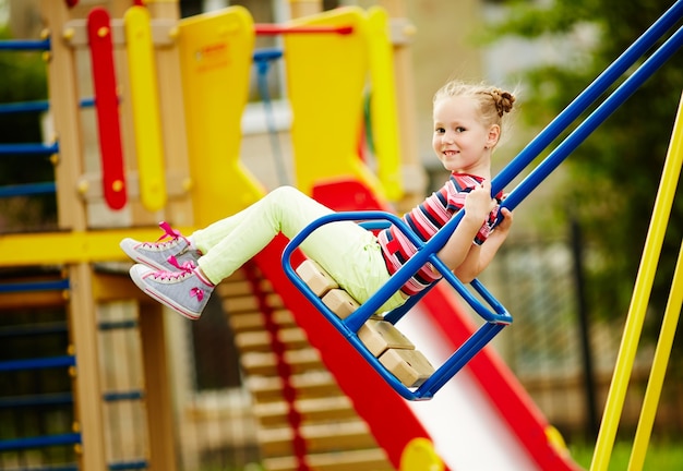 Free photo smiling girl on swing