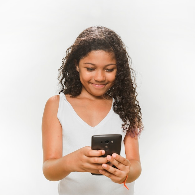 Smiling girl using mobile phone