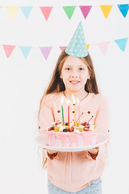 Free photo smiling girl with a birthday cake