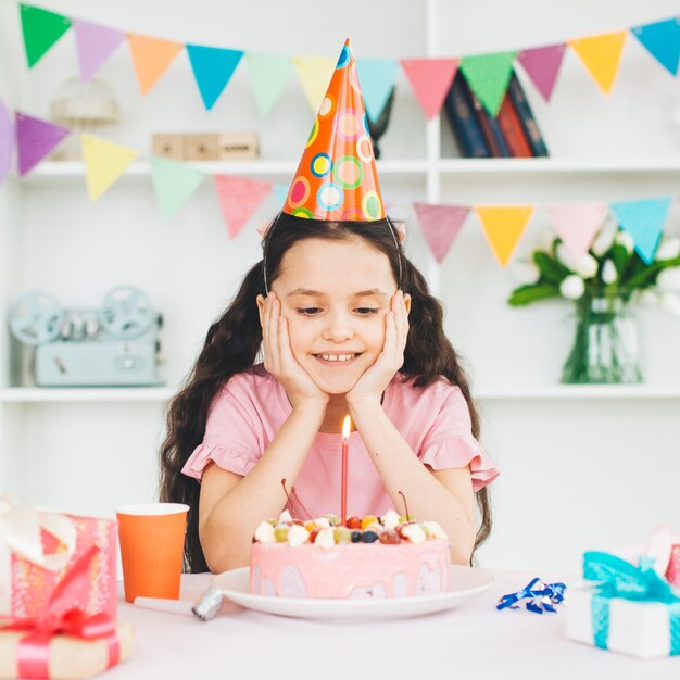 Smiling girl with a birthday cake