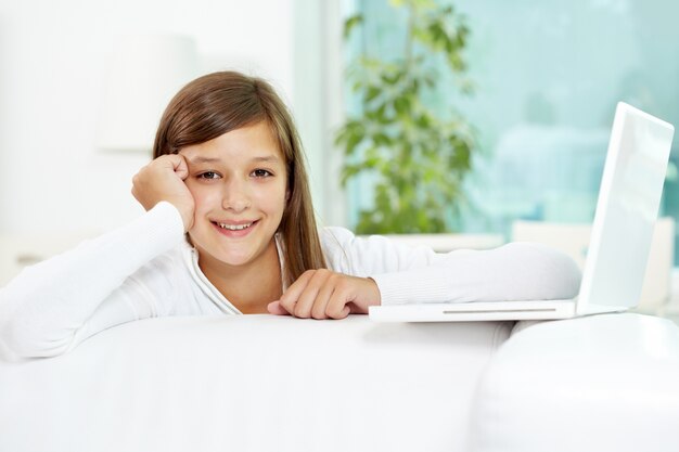 Smiling girl with a laptop