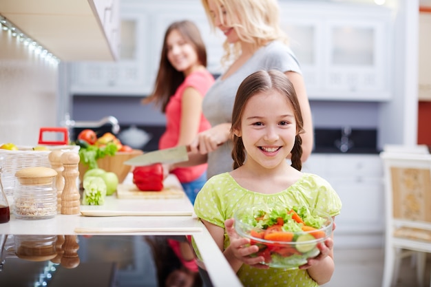 Smiling girl with salad