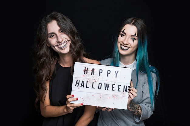 Smiling girls holding signboard