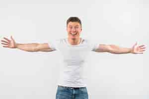 Free photo smiling handsome young man outstretching her arms isolated on white background