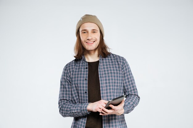 Smiling hipster holding tablet computer