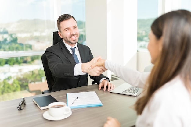 Free Photo smiling human resource manager congratulating candidate on successful job interview