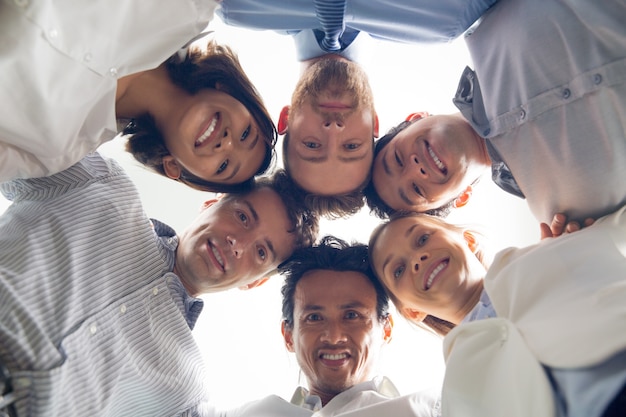 Smiling international business team huddling