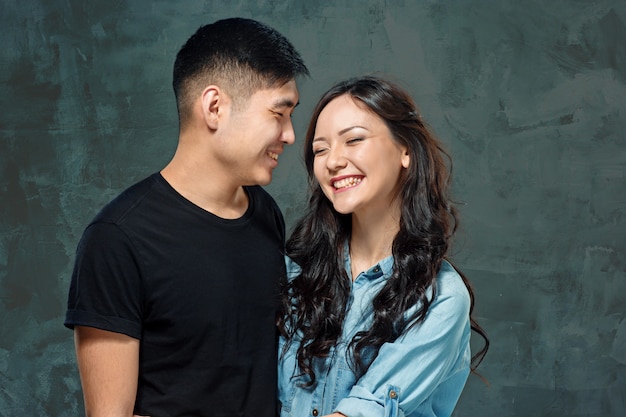 smiling Korean couple on gray