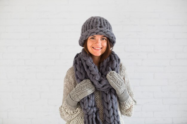 Smiling lady in mittens, hat and scarf 