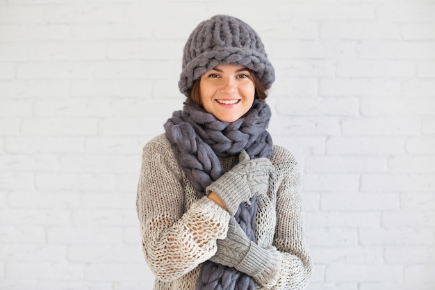 Smiling lady in mitts, hat and scarf