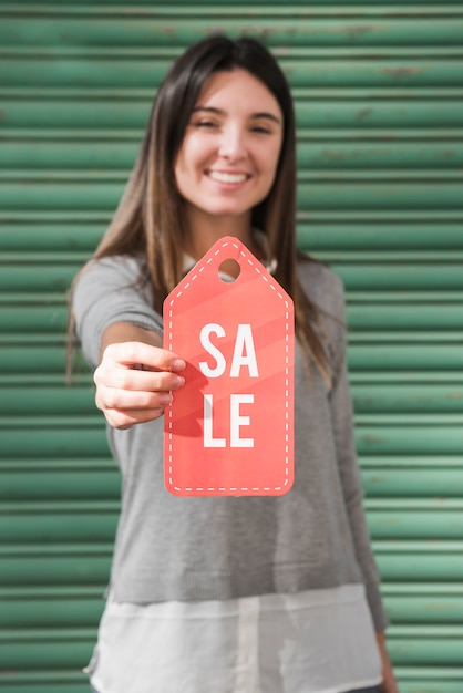 Smiling lady with sale tag