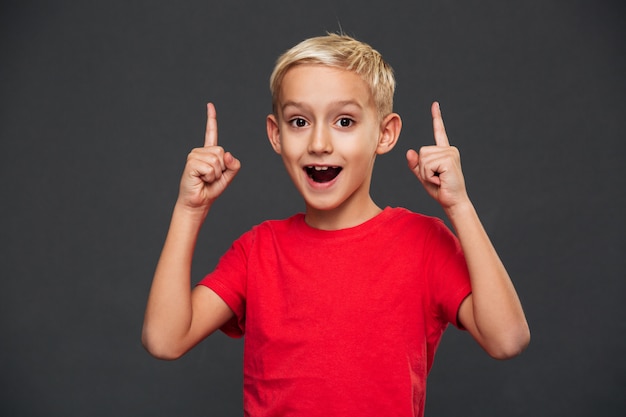 Smiling little boy child pointing.