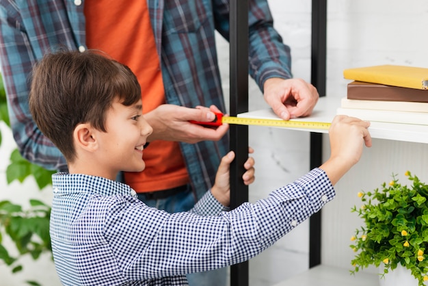 Free photo smiling little boy measuring a self