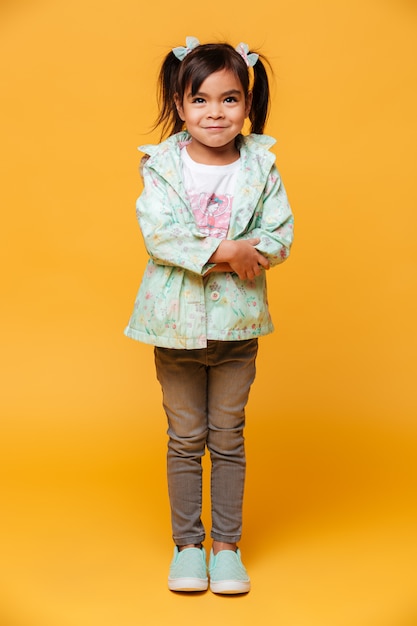 Smiling little girl child standing isolated