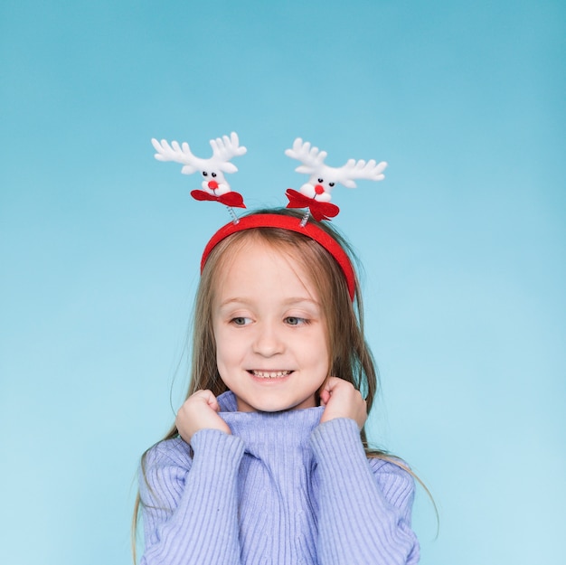 Smiling little girl posing on blue background