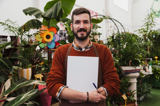 Smiling man in greenhouse