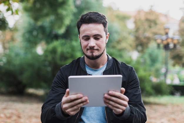 Smiling man looking in a tablet