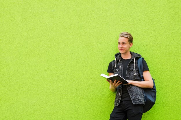 Smiling man posing with book