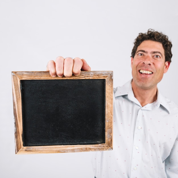 Smiling man presenting slate