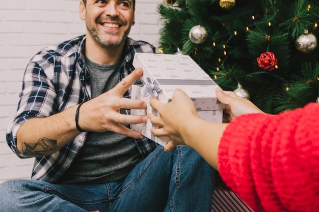 Free photo smiling man receiving present box