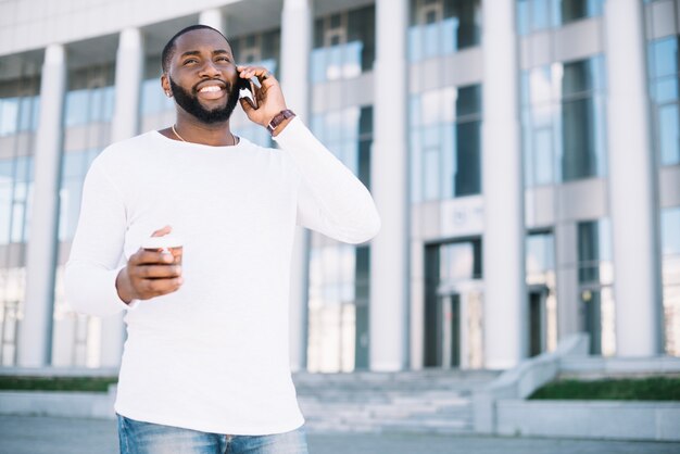 Smiling man speaking on phone