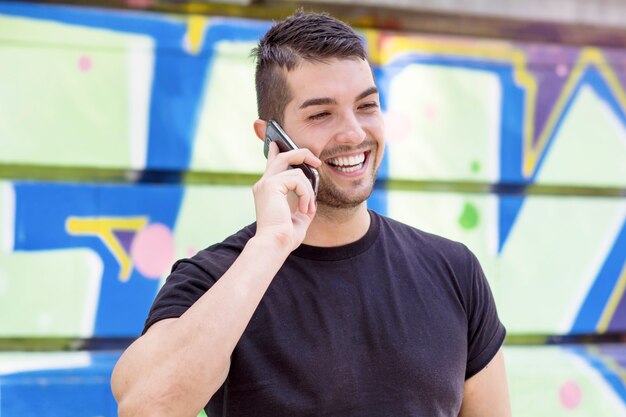 Smiling man talking on his phone