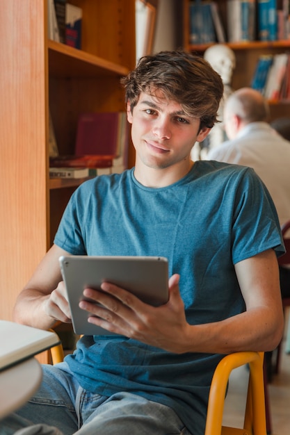 Smiling man using tablet