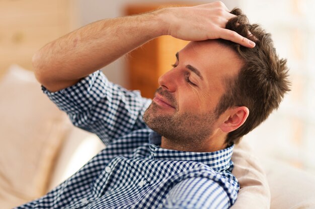 Smiling man with hand in hair