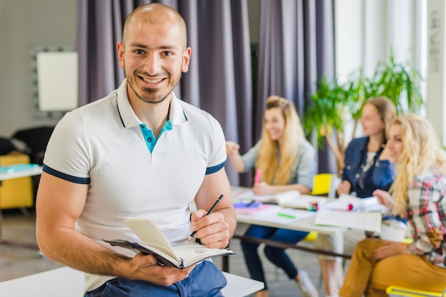 Free Photo smiling man with notebook