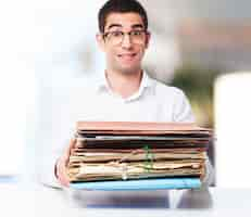 Free photo smiling man with a pile of papers in hands