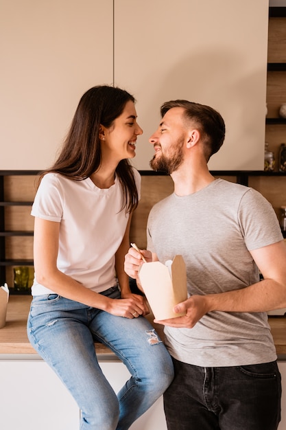 Smiling man and woman having lunch together at home