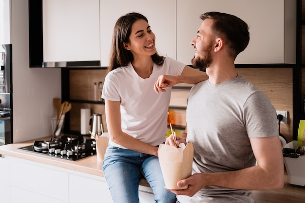 Smiling man and woman having lunch together at home