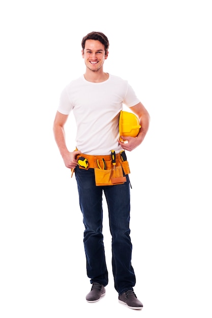 Smiling manual worker holding yellow hardhat