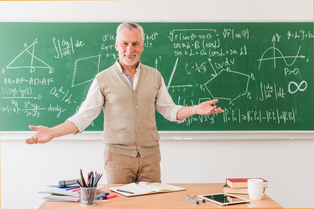 Smiling math teacher greeting auditorium