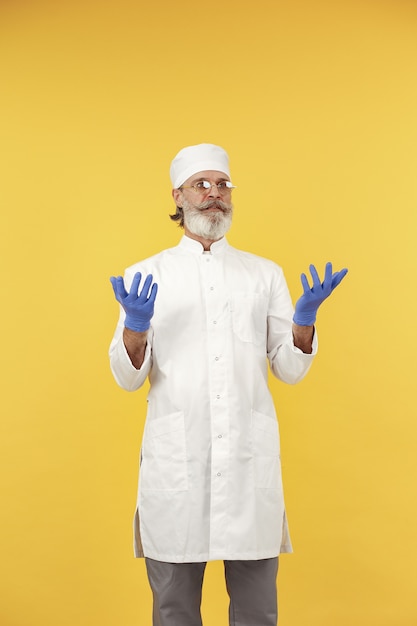 Free photo smiling medical doctor in glasses. isolated. man in a blue gloves.