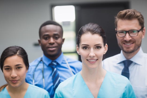 Free photo smiling medical team standing together in hospital corridor