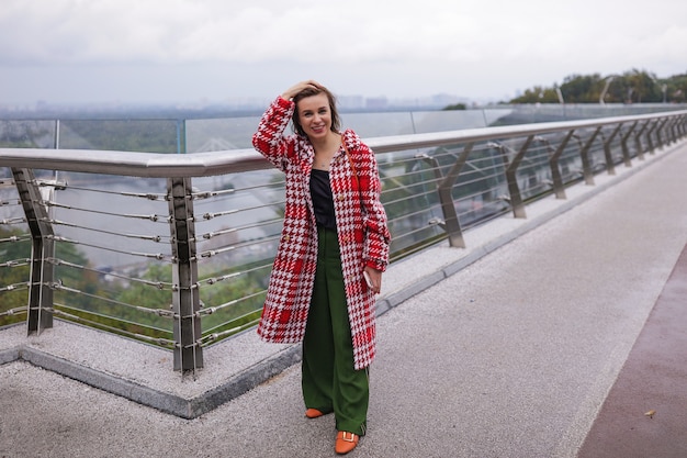 Free Photo a smiling middle age woman wearing autumn clothes.