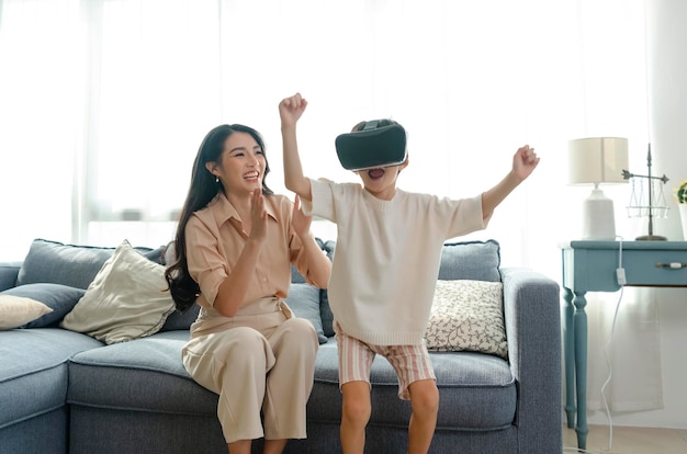 Smiling mother looking son playing games using virtual reality headsetVR at home Technology future concept